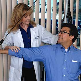 Tami Peavy, Physical Therapist, Practical Therapy4U, instructs client in techniques to relieve back pain. Photo: Angels Touch, Inc.